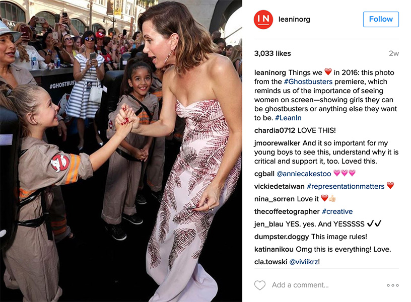 Kristen Wiig shaking hands with a young girl at the all-female cast Ghostbusters 2016 premier.
