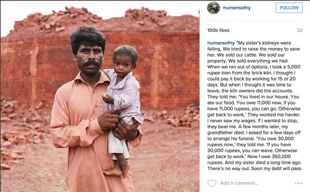 Man stands holding young boy somewhere in India.