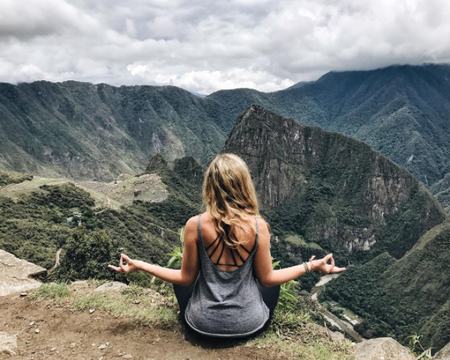wanderlust. girl doing yoga on mountains