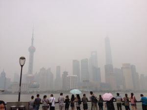 Visitors at the Bund in Shanghai using umbrellas to block out UV