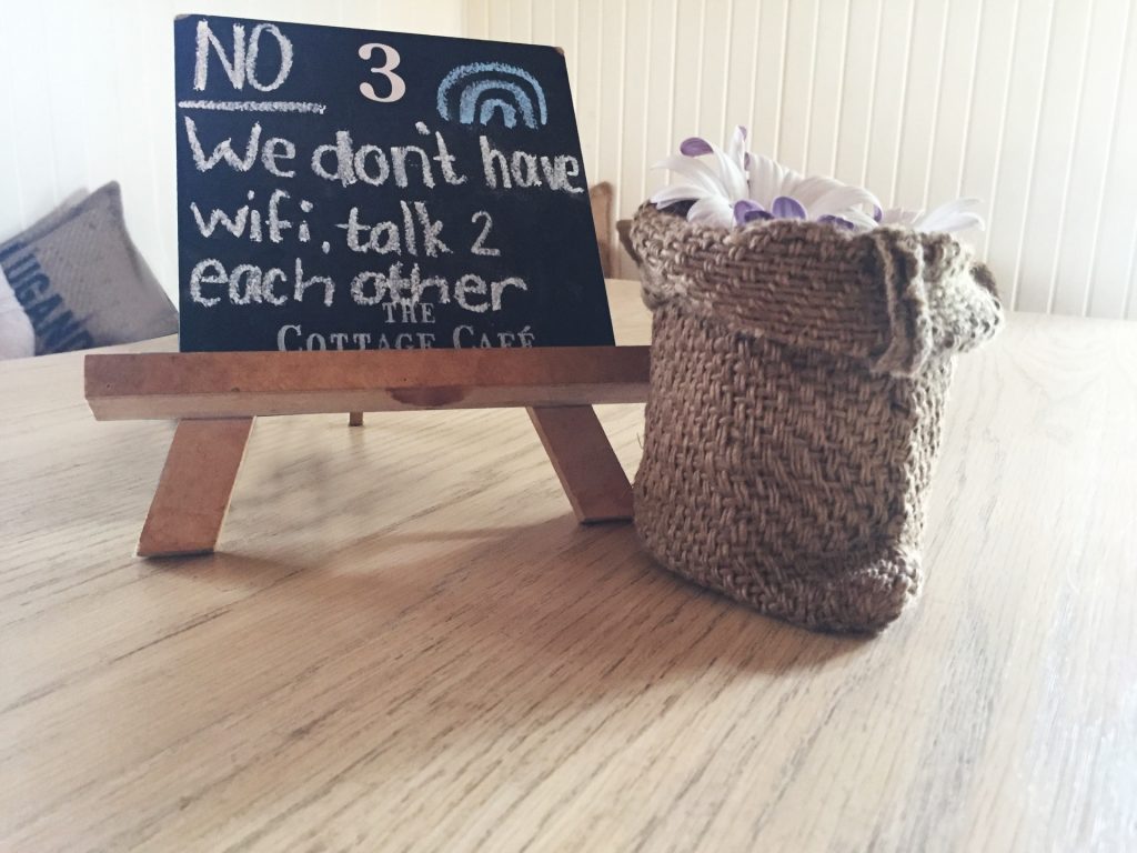 Photo of blackboard saying 'We don't have wifi, talk to each other'.