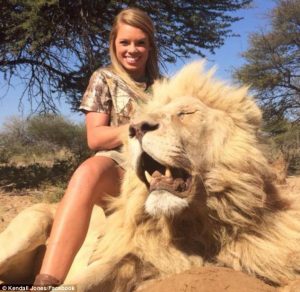 Kendall Jones posing with lion she shot and killed