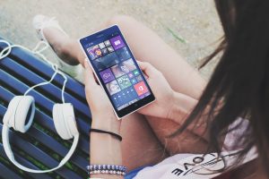 Teenager on smartphone with headphones