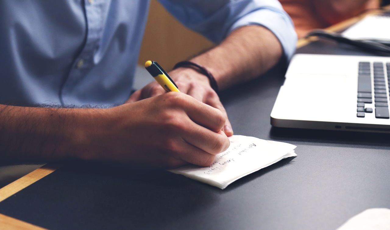 Photo of man taking notes