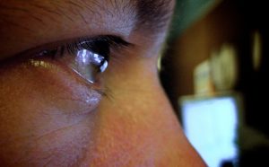 person staring at screen- reflection on eye