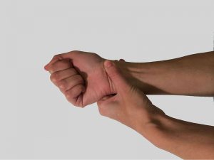 Person holding wrist as a symptom of RSI